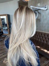 the back of a blonde woman's hair in a salon