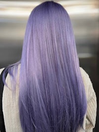the back view of a woman with purple hair