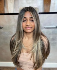a woman with long blonde hair in a salon