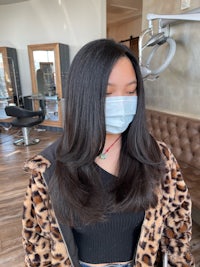 a woman wearing a mask in a salon