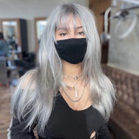 a woman wearing a mask in a salon