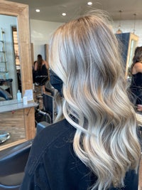 the back of a blonde woman's hair in a salon