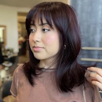 a woman in a salon looking at her hair