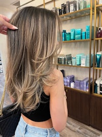 a woman is getting her hair done in a salon