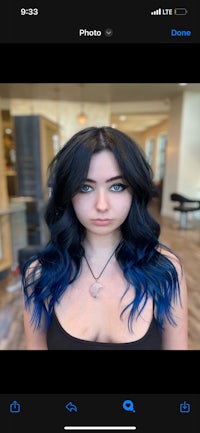 a picture of a woman with blue hair on her phone