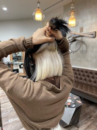 a woman is putting her hair up in a salon