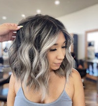 a woman is getting her hair done in a salon